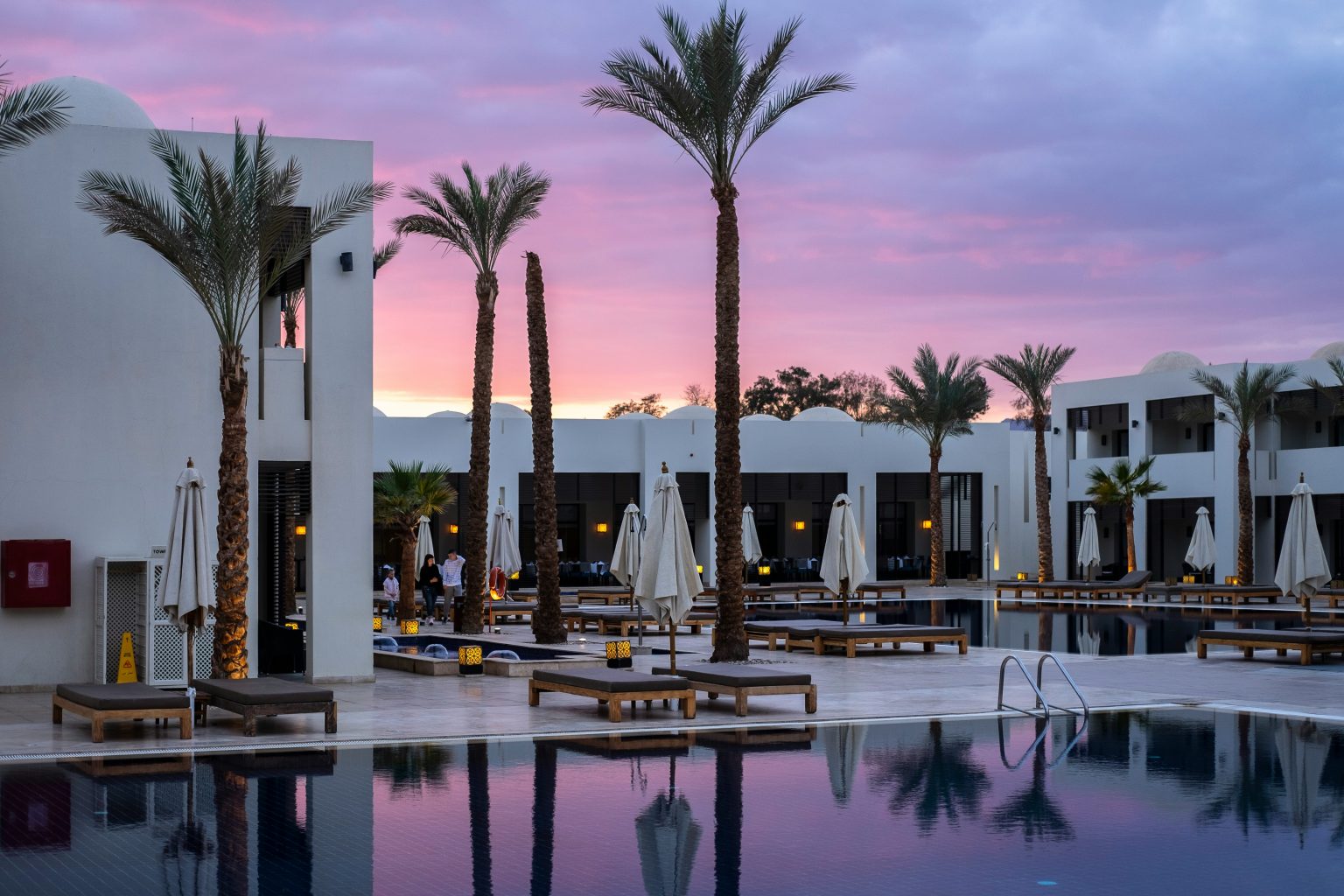 a large swimming pool surrounded by palm trees photo Eatery Club